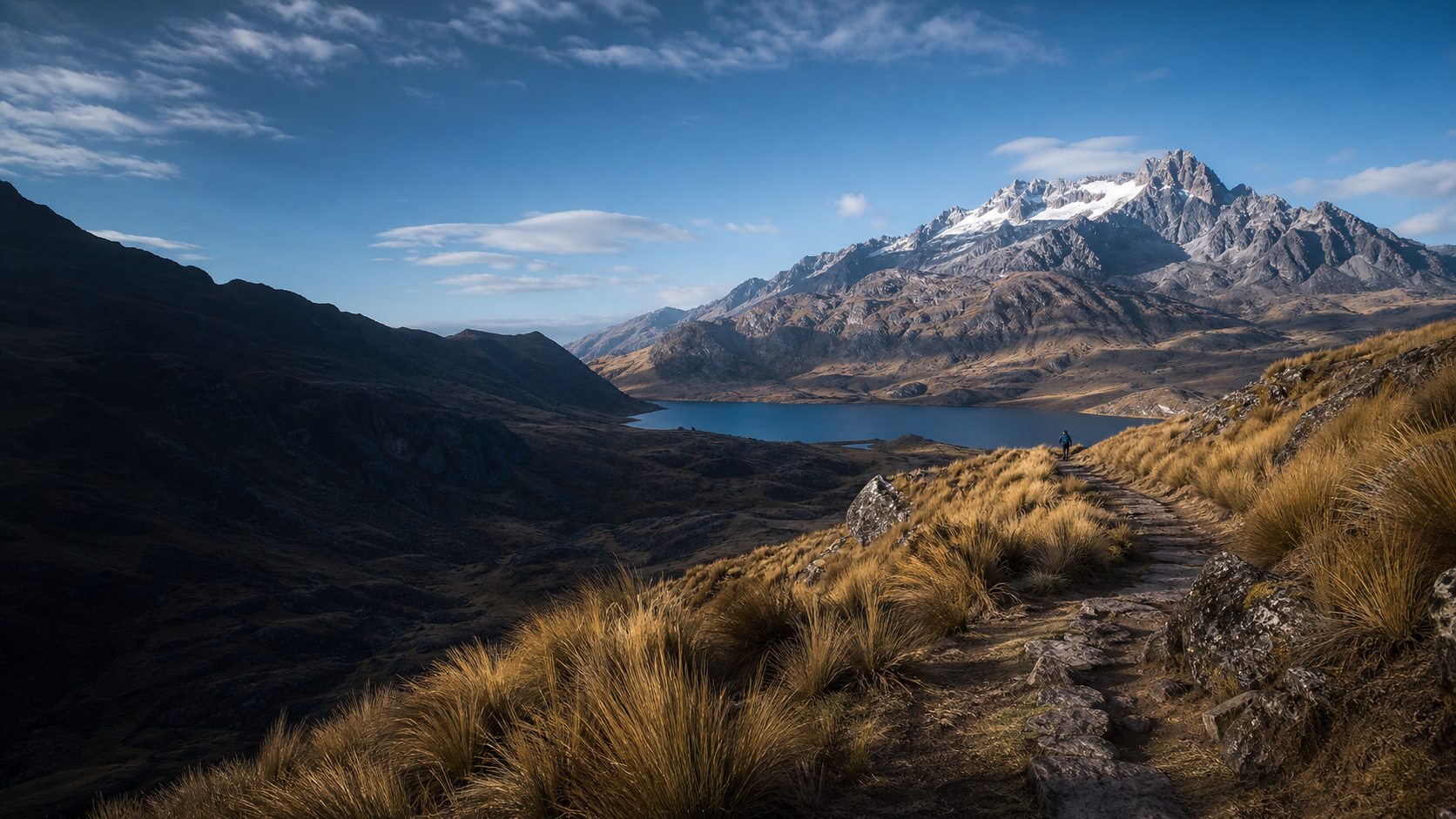 Sendero de trekking entre montañas y laguna del altiplano de Puno